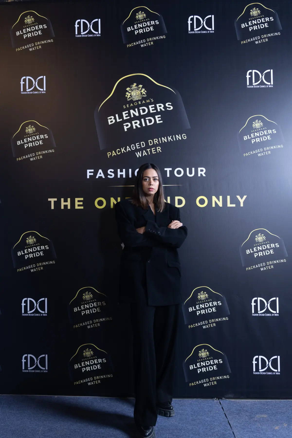 Woman in a minimalist all-black blazer and trousers at the Blenders Pride Fashion Tour