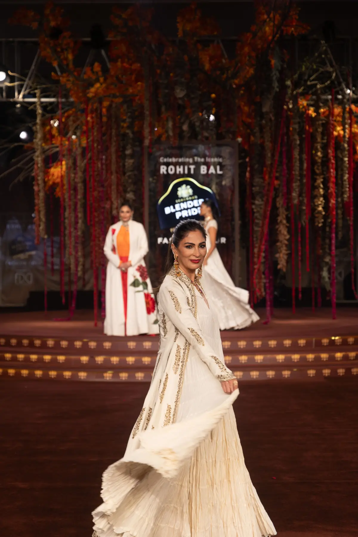 Model twirls in a flowing white Banarasi brocade anarkali gown with gold zari embroidery at Blenders Pride Fashion Tour